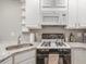 Well-equipped kitchen with white cabinetry, modern appliances, and granite countertops at 215 Piedmont Ne Ave # 904, Atlanta, GA 30308
