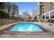 Outdoor pool with a sundeck and surrounding greenery at 215 Piedmont Ne Ave # 904, Atlanta, GA 30308