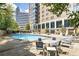 Outdoor pool surrounded by lounge chairs and tables at 215 Piedmont Ne Ave # 904, Atlanta, GA 30308