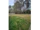 Lush backyard with ample space, mature trees, and healthy grass perfect for outdoor activities at 3348 Concord Se Cor, Conyers, GA 30013