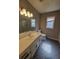 Neutral bathroom featuring patterned floor, white vanity, and well-lit mirror at 3348 Concord Se Cor, Conyers, GA 30013