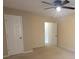 Bright bedroom with neutral walls and carpet, a ceiling fan, and white doors at 3348 Concord Se Cor, Conyers, GA 30013