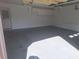 Clean, empty garage with overhead storage, painted walls, and easy access to a service door at 3348 Concord Se Cor, Conyers, GA 30013