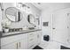 Modern bathroom boasts double sinks, round mirrors, and sleek fixtures for a spa-like experience at 503 Mcwilliams Se Rd, Atlanta, GA 30315