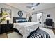 This bedroom features a fan, dark furniture, a bed, desk and entry to a luxury bathroom at 503 Mcwilliams Se Rd, Atlanta, GA 30315