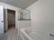 Bathroom featuring soaking tub and a glass shower with white tile surround at 1910 Victoria Way # 120, Conyers, GA 30013