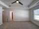 Spacious bedroom featuring neutral carpet and a tray ceiling with fan and bright window at 1910 Victoria Way # 120, Conyers, GA 30013