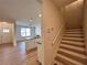 Bright entryway with vinyl plank flooring, staircase and an adjacent kitchen area at 1910 Victoria Way # 120, Conyers, GA 30013