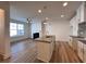 Modern kitchen featuring white cabinets, center island, and wood-look flooring at 1910 Victoria Way # 120, Conyers, GA 30013