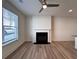 Cozy living room featuring a fireplace, bright windows, and a ceiling fan at 1910 Victoria Way # 120, Conyers, GA 30013