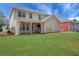 Spacious backyard features a covered patio, lush green grass and a view of the two-story home at 3485 Walnut Rdg, Atlanta, GA 30349