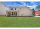 View of the well maintained backyard with a covered patio, offering an ideal space for outdoor relaxation and entertainment at 3485 Walnut Rdg, Atlanta, GA 30349