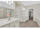 Bright bathroom featuring double sinks, walk-in shower, and soaking tub at 3485 Walnut Rdg, Atlanta, GA 30349