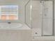Bathtub and separate glass enclosed shower offer a spa-like experience at 3485 Walnut Rdg, Atlanta, GA 30349