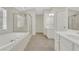 Luxurious bathroom with a soaking tub, separate shower, and double vanity sinks at 3485 Walnut Rdg, Atlanta, GA 30349