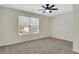 Bedroom with neutral carpet, ceiling fan, and natural light from a large window at 3485 Walnut Rdg, Atlanta, GA 30349