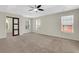 Spacious bedroom featuring neutral carpet, tray ceiling, large windows and walk through to bathroom at 3485 Walnut Rdg, Atlanta, GA 30349