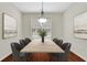 Formal dining room with a large table for eight and plenty of natural light at 3485 Walnut Rdg, Atlanta, GA 30349