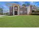 Elegant two-story home showcasing a well-manicured lawn and inviting double-door entrance at 3485 Walnut Rdg, Atlanta, GA 30349