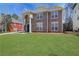 Traditional brick home featuring a well-manicured front yard at 3485 Walnut Rdg, Atlanta, GA 30349