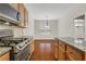 Modern kitchen showcasing stainless steel appliances, granite countertops, and warm wood cabinets at 3485 Walnut Rdg, Atlanta, GA 30349