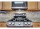 Close-up of a stainless steel oven and microwave in a modern kitchen with neutral-toned cabinets at 3485 Walnut Rdg, Atlanta, GA 30349