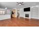 Open concept living room with fireplace adjacent to the kitchen and stairway at 3485 Walnut Rdg, Atlanta, GA 30349