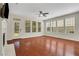Bright living room featuring a fireplace, ceiling fan, and a door that opens to the backyard at 3485 Walnut Rdg, Atlanta, GA 30349