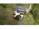 Aerial view of a home with a private pool and outdoor living space surrounded by mature trees at 12680 Old Surrey Pl, Roswell, GA 30075