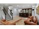 Basement wet bar area with tile flooring, staircase and plenty of room for entertaining guests at 12680 Old Surrey Pl, Roswell, GA 30075