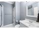 Bright bathroom with white vanity, framed mirror, toilet, and a shower with glass door at 12680 Old Surrey Pl, Roswell, GA 30075