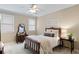 Cozy bedroom with neutral walls, carpet, windows, and a bed with coordinated furnishings at 12680 Old Surrey Pl, Roswell, GA 30075