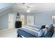 Spacious bedroom features a large bed, neutral walls, ensuite bathroom, and plush carpet at 12680 Old Surrey Pl, Roswell, GA 30075