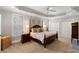 Charming bedroom with a four-poster bed, ceiling fan, neutral colors and natural light at 12680 Old Surrey Pl, Roswell, GA 30075