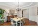 Traditional dining room featuring hardwood floors, a chandelier, and wainscoting at 12680 Old Surrey Pl, Roswell, GA 30075