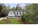 Charming two-story home with a welcoming front porch and meticulously landscaped yard at 12680 Old Surrey Pl, Roswell, GA 30075