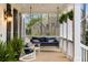 Relaxing front porch with cozy seating and charming details, perfect for enjoying the outdoors at 12680 Old Surrey Pl, Roswell, GA 30075
