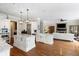 Spacious kitchen with white cabinetry, double islands, stainless appliances, and view to living room at 12680 Old Surrey Pl, Roswell, GA 30075