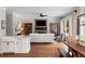 Open concept living room with stone fireplace, built-in cabinets, and eat-in kitchen area at 12680 Old Surrey Pl, Roswell, GA 30075