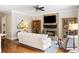 Cozy living room with stone fireplace, built-in cabinets, and abundant natural light from large windows at 12680 Old Surrey Pl, Roswell, GA 30075