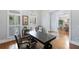 Home office with a large wooden desk, plantation shutters, and hardwood floors at 12680 Old Surrey Pl, Roswell, GA 30075
