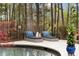 Tranquil poolside retreat with comfortable lounge chairs and serene, wooded views at 12680 Old Surrey Pl, Roswell, GA 30075