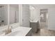 Stylish bathroom with double sinks, modern fixtures, and tiled floors at 13567 Tolstoy Drive, Covington, GA 30014
