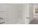 Bright bathroom with a white tub and shower combination at 13567 Tolstoy Drive, Covington, GA 30014