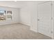 Well-lit bedroom with a view from a large window and a white door at 13567 Tolstoy Drive, Covington, GA 30014
