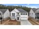 Charming two-story home showcasing a white exterior, black shutters, and a well-manicured lawn at 13567 Tolstoy Drive, Covington, GA 30014