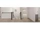 Hallway with plush carpeted floors leading to multiple rooms, with a black handrail staircase at 13567 Tolstoy Drive, Covington, GA 30014