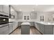 Spacious kitchen with gray cabinetry, stainless steel appliances, and large island at 13567 Tolstoy Drive, Covington, GA 30014