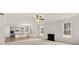 Open-concept living room with fireplace and hardwood floors extending into the kitchen at 13567 Tolstoy Drive, Covington, GA 30014