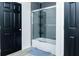 Updated bathroom with a glass-enclosed shower and contemporary tile design at 240 W Lake Nw Dr, Atlanta, GA 30314